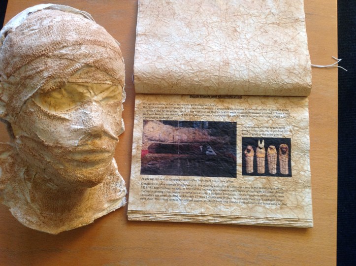 Beautifully aged folder about mummification with example mask. 